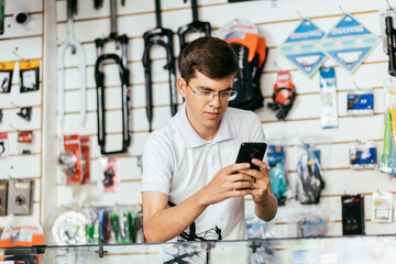 Bike shop owner working in his shop. Small business and entrepreneurship concept