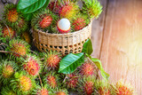 Fresh and ripe rambutan sweet tropical fruit peeled rambutan with leaf, Rambutan fruit on basket background harvest from the garden rambutan tree