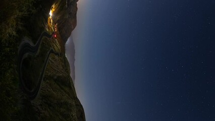 Wall Mural - night time lapse of a road winding through the mountains.