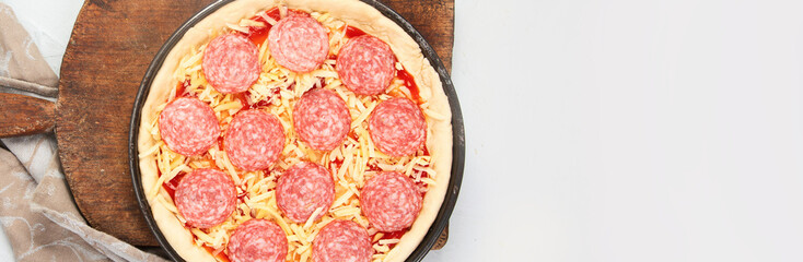 Pepperoni pizza on light background.