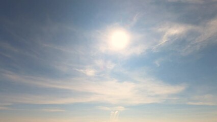 timelapse of bright sun light, sunbeams flares shining through sunset clouds cloudscape on beautiful