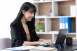 © PaeGAG - Portrait of Asian young female working on laptop at office