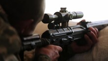 Ukrainian Sniper Looks Into The Optical Sight Of A Dragunov Sniper Rifle And Pulls The Trigger, The Bullet Flies Out. Close-up. War In Ukraine