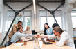© oneinchpunch - start up business team in the office. Multiethnic group working together on a new project in the conference room