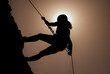 Silhouette of successful young female climber in the mountains Concept of self-improvement, motivation, movement inspiration, motivational goals.Adventurer, mental strength and physical health concept