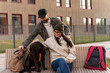 © NFstock - Happy spouses is enjoying time together with their dog. Woman stroking and embracing cute Labrador doggy while sitting at the bench during the walking. Youth lifestyle concept