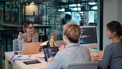 Young creative team of designer developing a new project in modern office. Developing programming and coding technologies