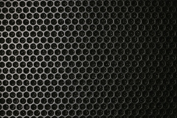 Safety net on the music speaker. Protective grid audio speakers. Close view of Black safety net. Metal perforated mesh, abstract pattern, Abstract black background. Professional audio equipment