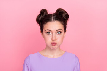 Wall Mural - Portrait of attractive funny girl blowing cheeks fooling tease isolated over pink pastel color background