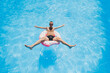 © Дмитрий Ткачук - A young man in sunglasses and shorts is relaxing on an inflatable donut in the pool. Summer vacation