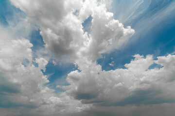 Wall Mural - Beautiful white clouds on a bright blue background.