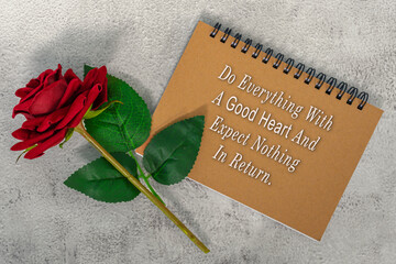 Wall Mural - Motivational and inspirational quote on brown note book with red roses.