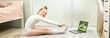 Little gymnast in a white leotard at home, studying remotely. Gymnastics lessons at home. Gymnastics lessons online