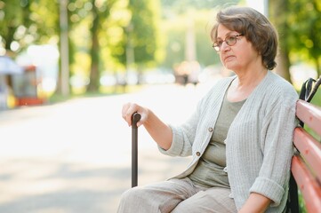 Wall Mural - Portrait of a happy Senior woman in summer park