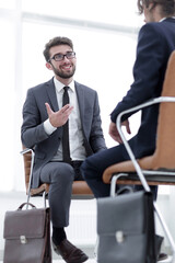 Canvas Print - Two businessmen holding briefcases near themselves