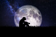 Leinwandbild Motiv silhouette of a person in the night. heartbroken and lonely man On the background of the beautiful moon. Image elements furnished by NASA.