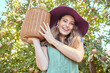 © Jade M/peopleimages.com - Portrait of apple farmer harvesting fresh fruit on farm. Happy young woman using a basket to pick and harvest ripe apples on her sustainable orchard. Surrounded by green plants, growth or agriculture