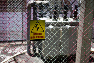 A high-voltage transformer in a cage protects against early morning current