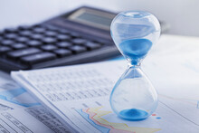 Best Time For Investment. Hourglass, Financial Charts And Calculator.