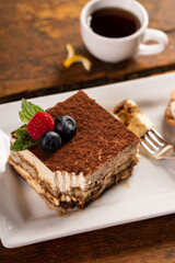 Wall Mural - Tiramisu dessert served on a white plate with espresso