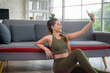 © tonefotografia - Young fitness woman in sportswear using smart phone while exercising at home, Healthy and Lifestyles.