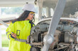 © reewungjunerr - Technician fixing the engine of the airplane,Female aerospace engineering checking aircraft engines,Asian mechanic maintenance inspects plane engine