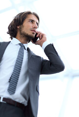 Canvas Print - businessman talking on mobile .isolated on white.