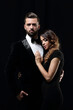 © ASDF - portrait of fashion couple on black background