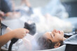 © chokniti - Young woman pampering herself at salon with hair spa, hair cut and hair wash with steam in salon