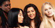 © iordani - young pretty african and caucasian women posing cheerful together on brown background, lifestyle diverse nationality people concept