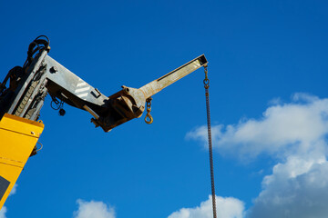 Close up of a yellow crane lifting goods