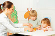 Mother play educative games together with little children