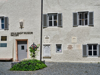 Wall Mural - The grave of Franz Gruber, the composer of the song Silent Night, and the facade of his museum house with panels, Hallein, Austria