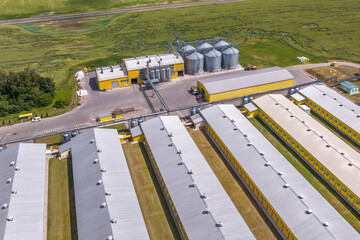 Wall Mural - aerial view on silos and agro-industrial livestock complex on agro-processing and manufacturing plant with modern granary elevator. chicken farm. rows of chicken coop