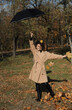 girl with umbrella in autumn park