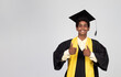 Portrait of graduate teen latin boy student in black graduation gown with hat, - isolated on background. Child back to school and educational concept.