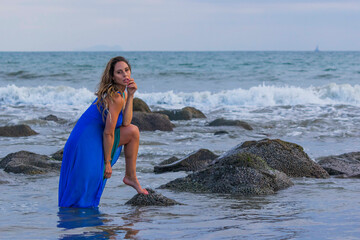 Wall Mural - Lovely Brunette Latin Model Poses Outdoors On A Beach At Sunset