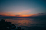 Fototapeta Zachód słońca - Fiery Amber sunset over the oceanside