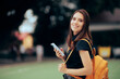 © nicoletaionescu - Happy Woman Reading a Text Massage Wearing a Yellow Backpack