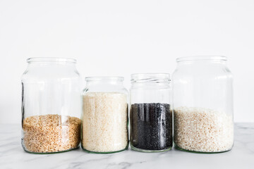 pantry jars with different types of rice including black brown arborio and sushi rice, simple staple ingredients