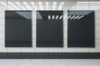 Front view on three blank black advertising screens on light glossy ceramic tales wall with lamps reflection above light grey floor in empty underground hall. 3D rendering, mock up