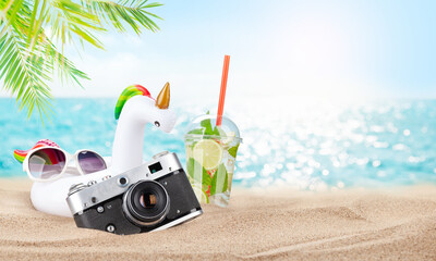 Wall Mural - Retro camera and mojito cocktail on tropical beach