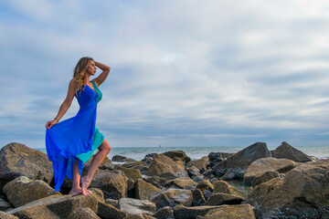 Wall Mural - Lovely Brunette Latin Model Poses Outdoors On A Beach At Sunset