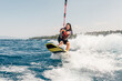 © Connect Images - Woman wakeboarding at lake