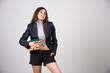 © rastockinc - Smiling business woman holding a stack of books