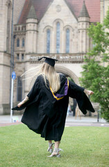 Portrait of a happy woman on her graduation day at university. Education and people.