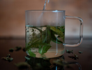 Glass mug with vervain tea