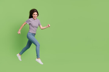 Poster - Full length body size view of attractive cheerful thin girl jumping running copy space ad isolated on bright green color background