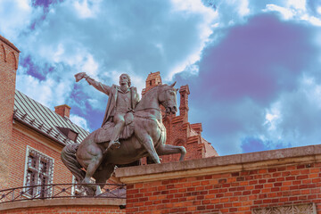 Close-up of an equestrian statue with a rider against a blue sky on a sunny day at the western entrance to the Wawel Royal Castle in Krakow, a gift to Poland on behalf of the people of Dresden