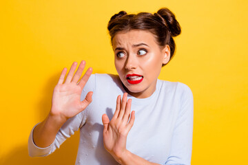 Wall Mural - photo of terrified young female try to avoid annoying person asking to stop isolated on yellow color
